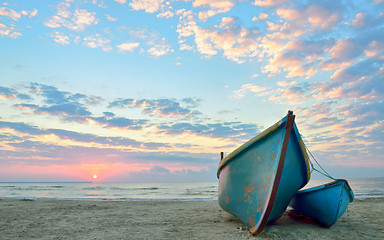 Image showing sunrise over an  wooden fishing boats