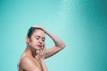 Image showing Woman enjoying water in the shower under a jet