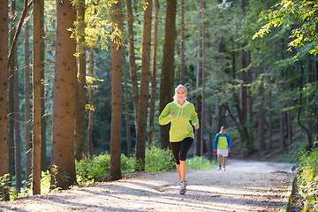 Image showing Pretty young girl runner in the forest. 