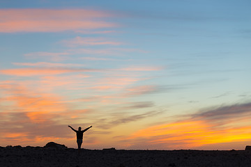 Image showing Woman enjoying freedom at sunset.