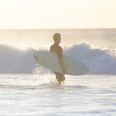 Image showing Surfers on beach with surfboard.