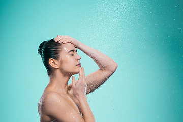 Image showing Woman enjoying water in the shower under a jet