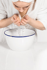 Image showing Woman cleaning face in bathroom