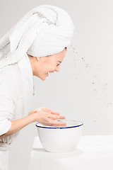 Image showing Woman cleaning face in bathroom