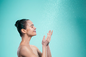 Image showing Woman enjoying water in the shower under a jet
