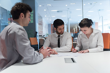 Image showing young couple signing contract documents on partners back