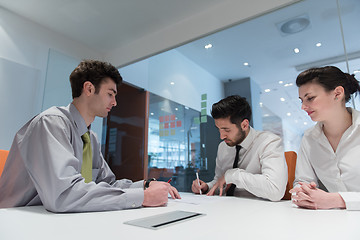 Image showing young couple signing contract documents on partners back