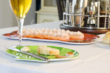 Image showing Close up on sliced bread with butter on a table