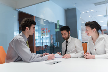 Image showing young couple signing contract documents on partners back