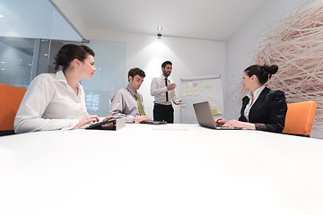 Image showing business people group brainstorming and taking notes to flip boa