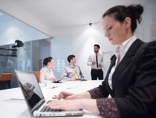 Image showing young business woman on meeting  using laptop computer