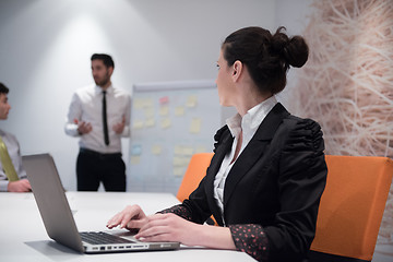 Image showing young business woman on meeting  using laptop computer