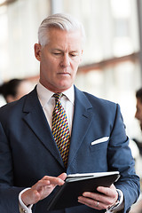 Image showing senior business man working on tablet computer