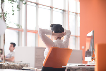 Image showing happy young business woman relaxing and geting insiration