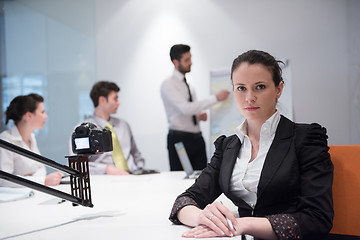 Image showing young business woman on meeting  using laptop computer