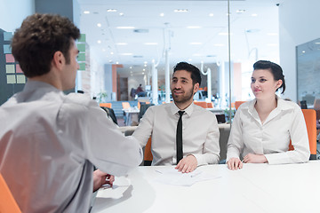 Image showing young couple signing contract documents on partners back