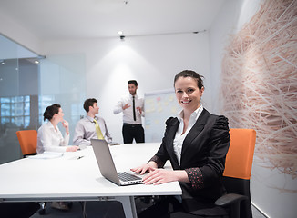 Image showing young business woman on meeting  using laptop computer