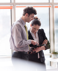 Image showing young couple working on flip board at office