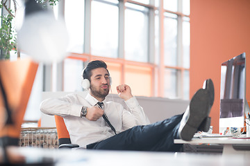 Image showing relaxed young business man at office