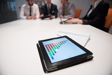 Image showing close up of touchpad with analytics documents at business meetin