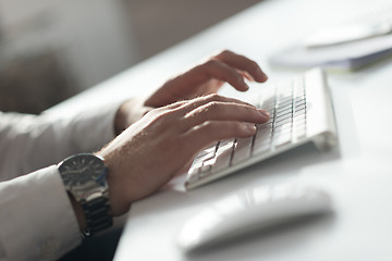 Image showing hands typing on desktop computer