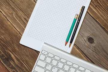 Image showing Computer keyboard, notebook and pen