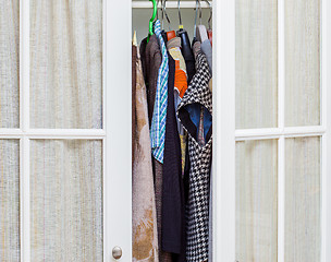 Image showing clothes in a white wardrobe