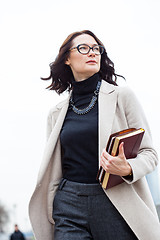 Image showing dark-haired middle-aged woman with books