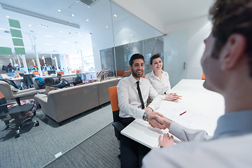 Image showing young couple signing contract documents on partners back