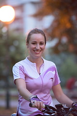 Image showing portrait of sporty woman with bike in park