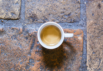 Image showing cup of coffee on a rustic floor