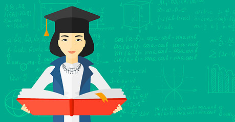 Image showing Woman in graduation cap holding book.