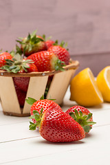 Image showing Strawberries in a small basket and lemon