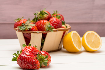 Image showing Strawberries in a small basket and lemon