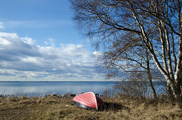 Image showing Small rowing boat up side down by the coast