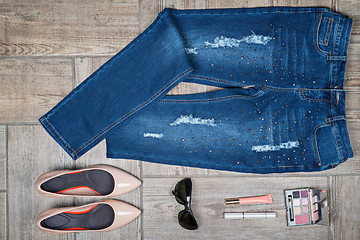 Image showing Overhead view of woman\'s jeans and accessories