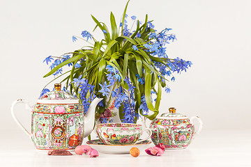 Image showing Tea and bouquet of  blue primroses on the table