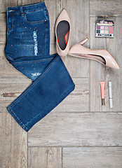 Image showing Flat lay photo of girl\'s jeans and accessories