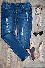 Image showing View from above of woman\'s jeans and accessories