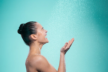 Image showing Woman enjoying water in the shower under a jet