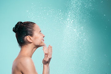 Image showing Woman enjoying water in the shower under a jet