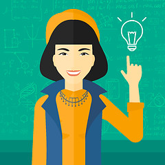 Image showing Woman pointing at light bulb.