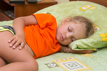 Image showing Little girl sleeps on his side in his hand under the pillow of the bed