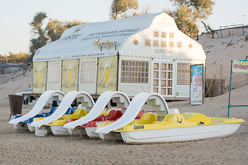 Image showing Anapa, Russia - September 21, 2015: Water catamarans are on the sand in front of a cafe on the beach in the early morning