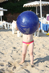 Image showing Baby girl and her big blue ball