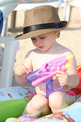 Image showing Baby girl playing on the beach