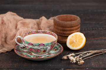 Image showing Tea with  lemon and primroses on the table