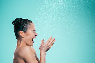 Image showing Woman enjoying water in the shower under a jet