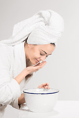 Image showing Young woman washing face with clean water