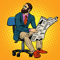 Image showing Bearded businessman reading a newspaper